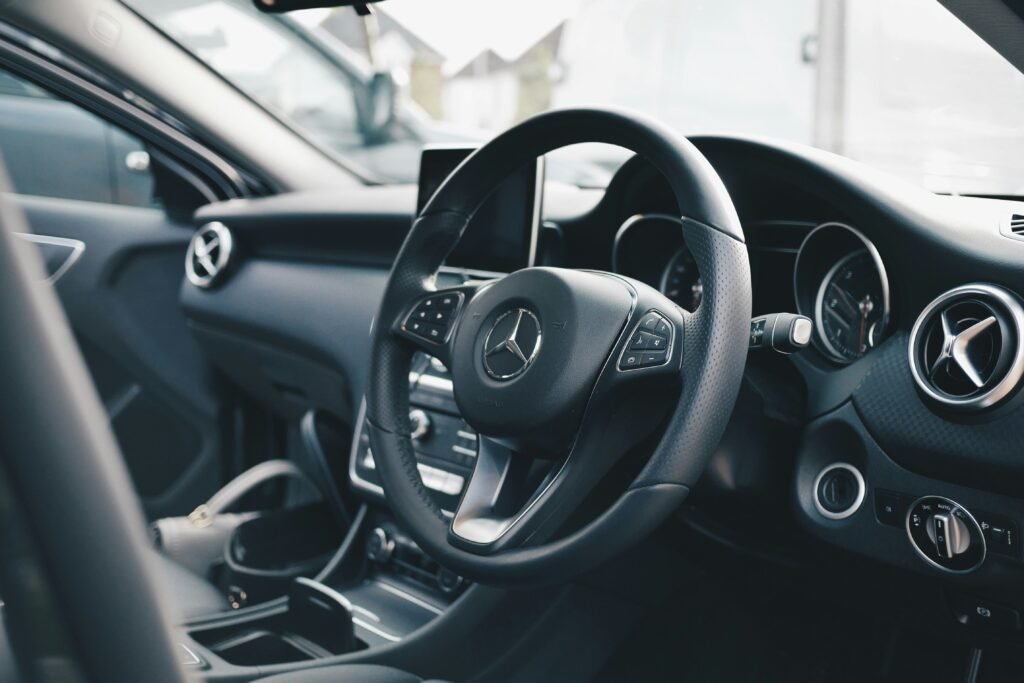 Close-up of a modern car interior showing a textured steering wheel cover — highlighting comfort and safety benefits.
