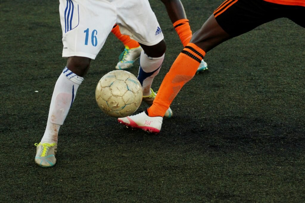 Close-up action between Plymouth Argyle and QPR footballers contesting possession during a competitive EFL match in 2025, showcasing player intensity and tactical gameplay on the pitch